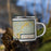 Right View Custom Logan Ohio Map Enamel Mug in Woodblock on Grass With Trees in Background
