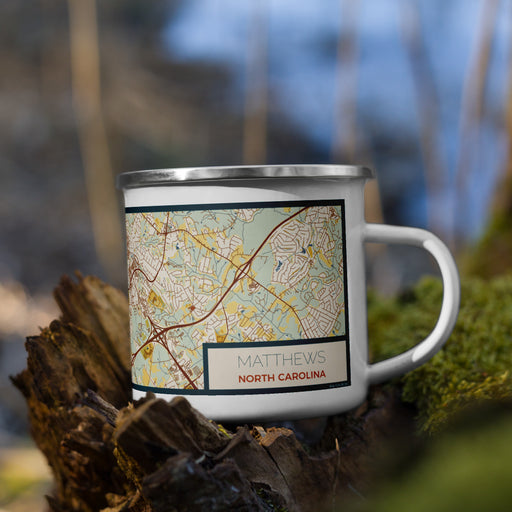 Right View Custom Matthews North Carolina Map Enamel Mug in Woodblock on Grass With Trees in Background