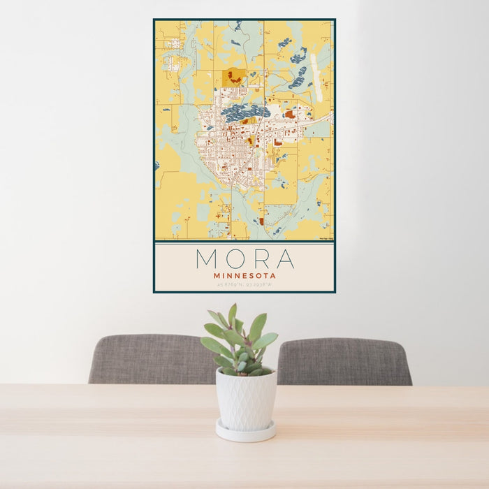 24x36 Mora Minnesota Map Print Portrait Orientation in Woodblock Style Behind 2 Chairs Table and Potted Plant