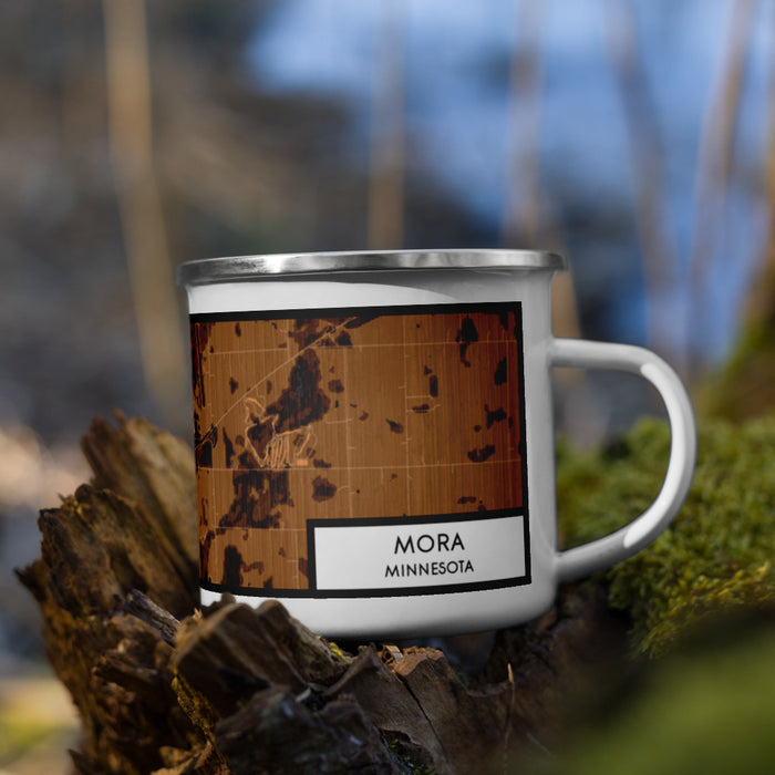 Right View Custom Mora Minnesota Map Enamel Mug in Ember on Grass With Trees in Background