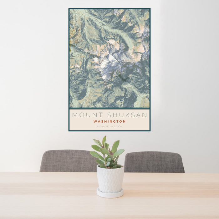 24x36 Mount Shuksan Washington Map Print Portrait Orientation in Woodblock Style Behind 2 Chairs Table and Potted Plant