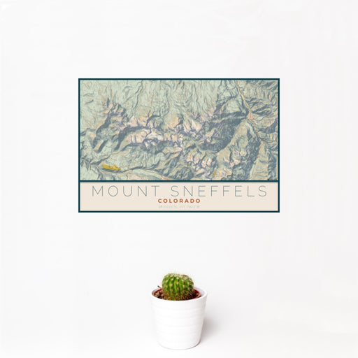 12x18 Mount Sneffels Colorado Map Print Landscape Orientation in Woodblock Style With Small Cactus Plant in White Planter