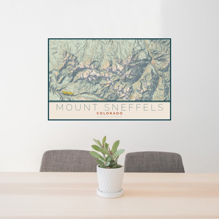 24x36 Mount Sneffels Colorado Map Print Lanscape Orientation in Woodblock Style Behind 2 Chairs Table and Potted Plant