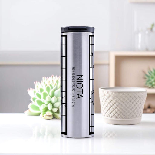 Niota Tennessee Custom City Map Inscription Coordinates on 17oz Stainless Steel Insulated Tumbler in Tactile Lines with Succulent in Background