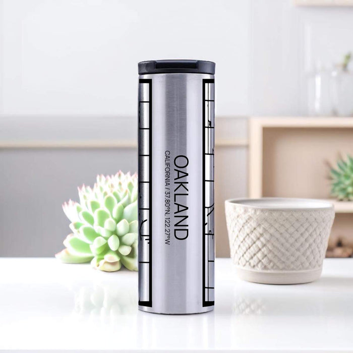 Oakland California Custom City Map Inscription Coordinates on 17oz Stainless Steel Insulated Tumbler in Tactile Lines with Succulent in Background