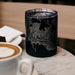 10oz Stainless Steel Insulated Cup in Black with Custom Engraved Map on Table next to Coffee Cup