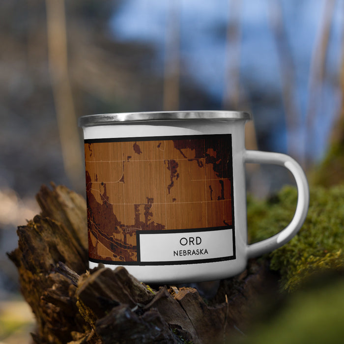 Right View Custom Ord Nebraska Map Enamel Mug in Ember on Grass With Trees in Background