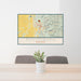 24x36 Philipsburg Montana Map Print Lanscape Orientation in Woodblock Style Behind 2 Chairs Table and Potted Plant