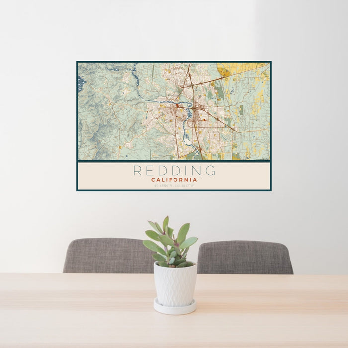 24x36 Redding California Map Print Lanscape Orientation in Woodblock Style Behind 2 Chairs Table and Potted Plant