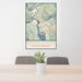 24x36 Revelstoke British Columbia Map Print Portrait Orientation in Woodblock Style Behind 2 Chairs Table and Potted Plant