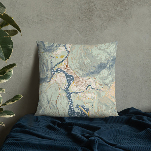 Custom Revelstoke British Columbia Map Throw Pillow in Woodblock on Bedding Against Wall