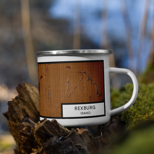 Right View Custom Rexburg Idaho Map Enamel Mug in Ember on Grass With Trees in Background