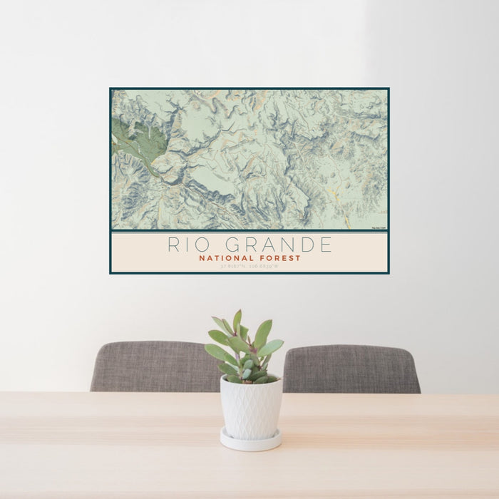 24x36 Rio Grande National Forest Map Print Lanscape Orientation in Woodblock Style Behind 2 Chairs Table and Potted Plant