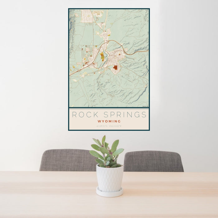 24x36 Rock Springs Wyoming Map Print Portrait Orientation in Woodblock Style Behind 2 Chairs Table and Potted Plant