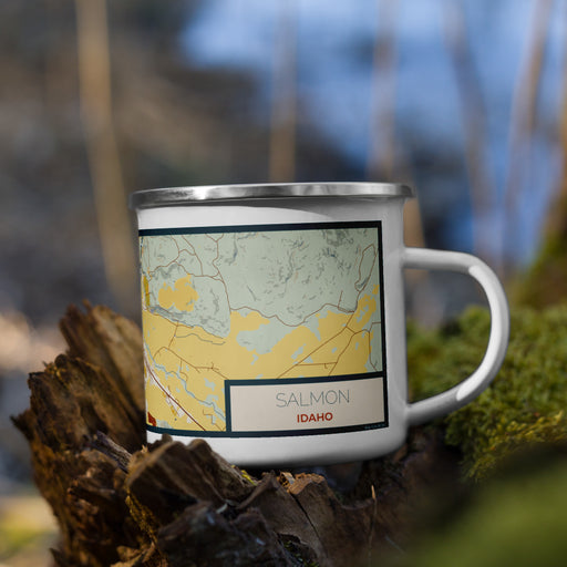 Right View Custom Salmon Idaho Map Enamel Mug in Woodblock on Grass With Trees in Background