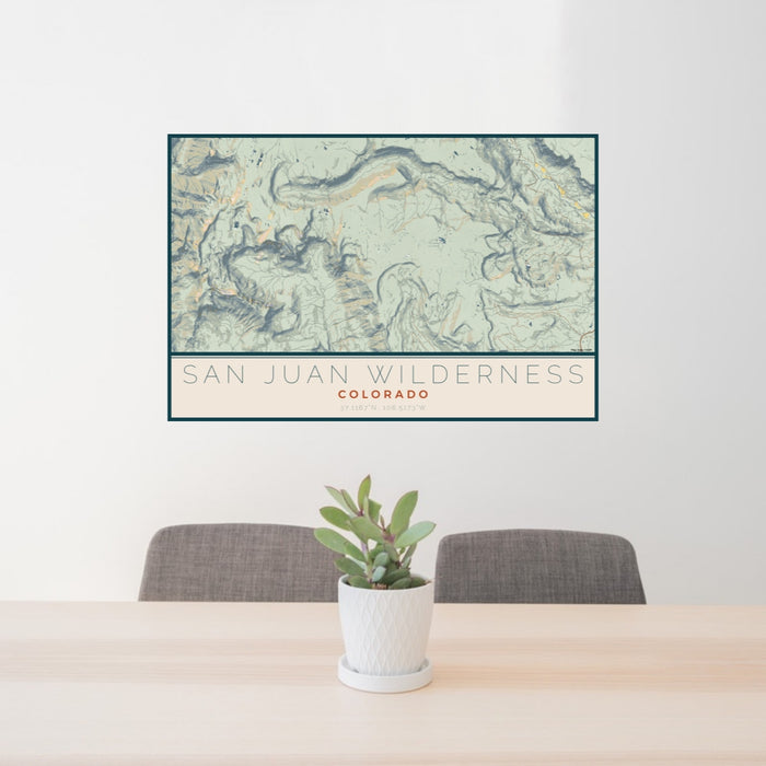 24x36 San Juan Wilderness Colorado Map Print Lanscape Orientation in Woodblock Style Behind 2 Chairs Table and Potted Plant