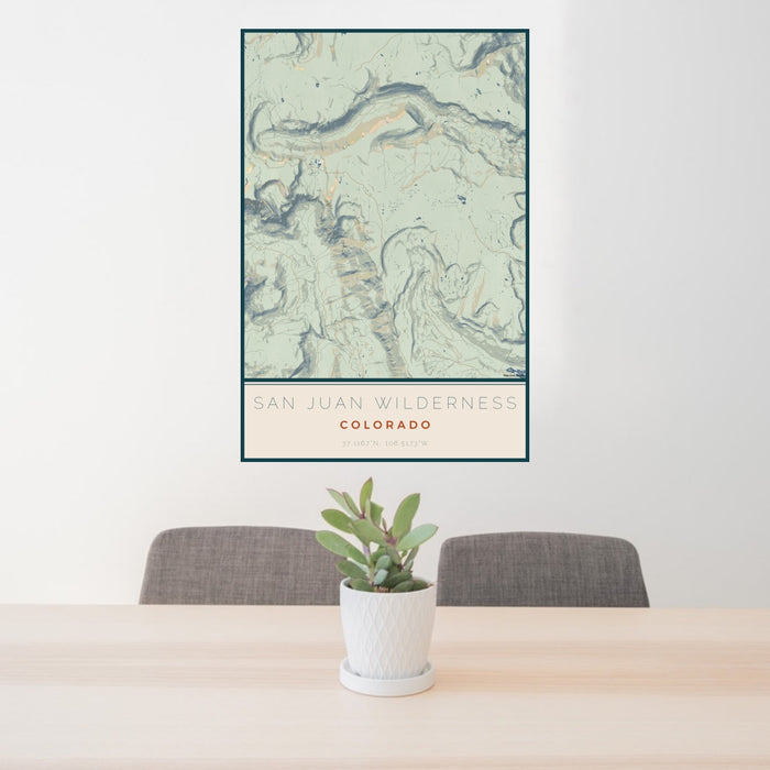 24x36 San Juan Wilderness Colorado Map Print Portrait Orientation in Woodblock Style Behind 2 Chairs Table and Potted Plant