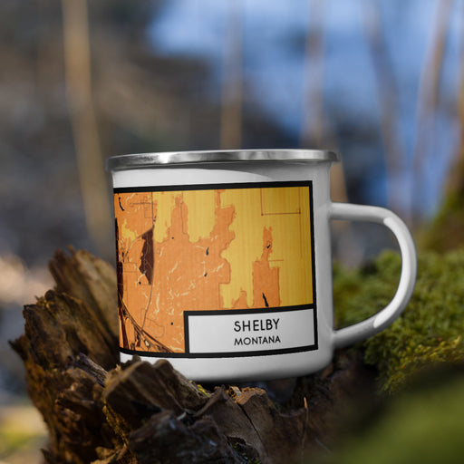 Right View Custom Shelby Montana Map Enamel Mug in Ember on Grass With Trees in Background