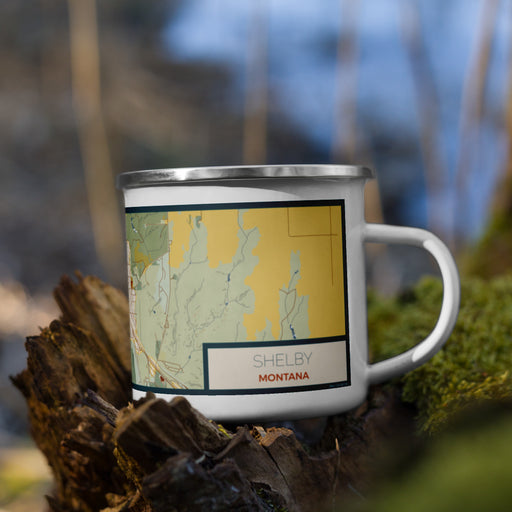 Right View Custom Shelby Montana Map Enamel Mug in Woodblock on Grass With Trees in Background