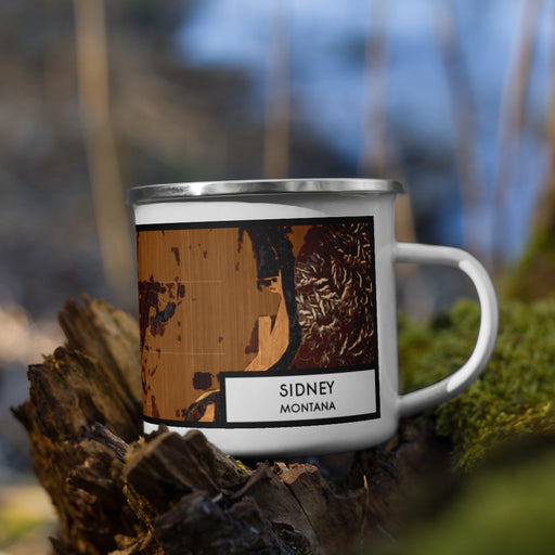 Right View Custom Sidney Montana Map Enamel Mug in Ember on Grass With Trees in Background
