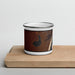 Front View Custom Soda Lake Wyoming Map Enamel Mug in Ember on Cutting Board