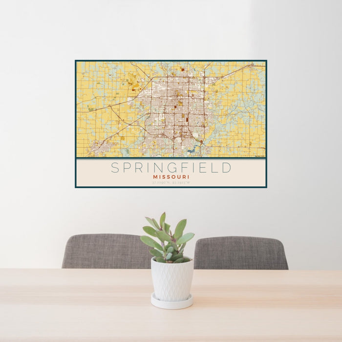 24x36 Springfield Missouri Map Print Lanscape Orientation in Woodblock Style Behind 2 Chairs Table and Potted Plant