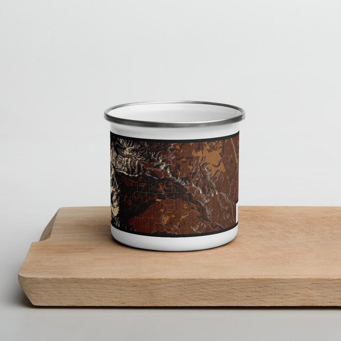 Front View Custom Story Wyoming Map Enamel Mug in Ember on Cutting Board
