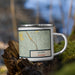 Right View Custom Story Wyoming Map Enamel Mug in Woodblock on Grass With Trees in Background