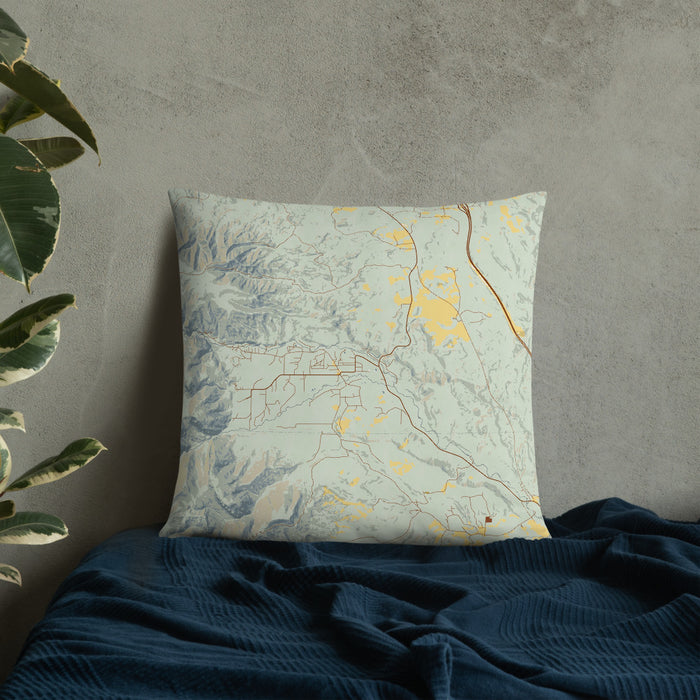 Custom Story Wyoming Map Throw Pillow in Woodblock on Bedding Against Wall
