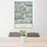 24x36 Swan Range Montana Map Print Portrait Orientation in Woodblock Style Behind 2 Chairs Table and Potted Plant