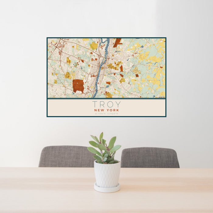 24x36 Troy New York Map Print Lanscape Orientation in Woodblock Style Behind 2 Chairs Table and Potted Plant