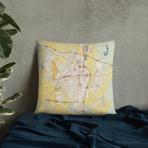 Custom Tupelo Mississippi Map Throw Pillow in Woodblock on Bedding Against Wall