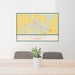 24x36 Ulysses Kansas Map Print Lanscape Orientation in Woodblock Style Behind 2 Chairs Table and Potted Plant