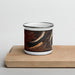 Front View Custom Willow Lake Wyoming Map Enamel Mug in Ember on Cutting Board