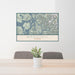 24x36 Wrangell Alaska Map Print Landscape Orientation in Woodblock Style Behind 2 Chairs Table and Potted Plant
