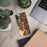 Custom Aliso Viejo California Map Phone Case in Ember on Table with Laptop and Plant