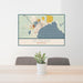 24x36 Alpena Michigan Map Print Lanscape Orientation in Woodblock Style Behind 2 Chairs Table and Potted Plant
