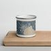 Front View Custom Alpena Michigan Map Enamel Mug in Afternoon on Cutting Board