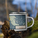 Right View Custom Alpena Michigan Map Enamel Mug in Woodblock on Grass With Trees in Background