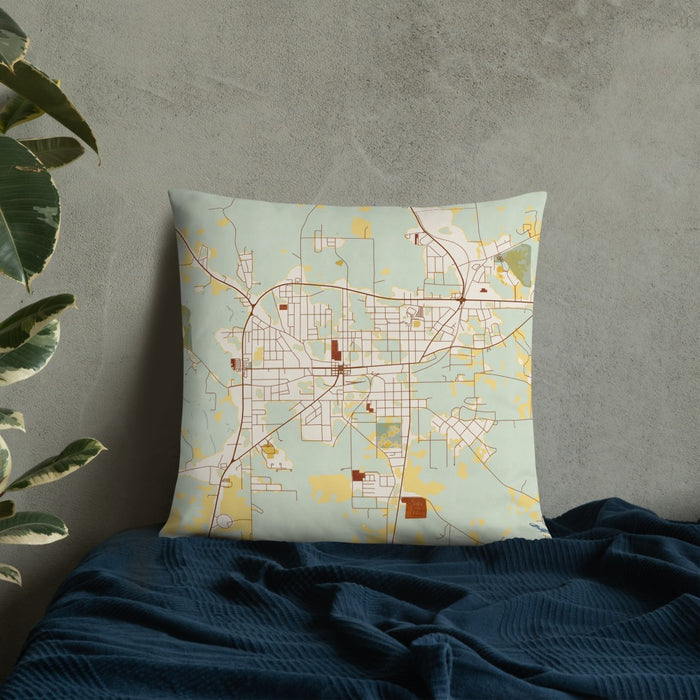 Custom Andalusia Alabama Map Throw Pillow in Woodblock on Bedding Against Wall