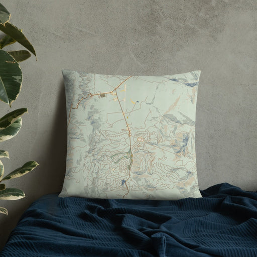 Custom Angel Fire New Mexico Map Throw Pillow in Woodblock on Bedding Against Wall