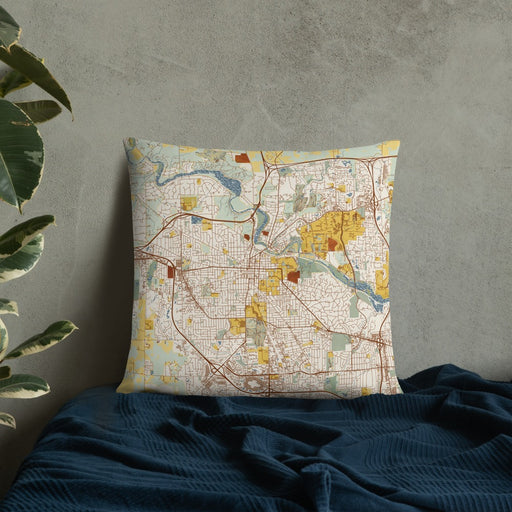 Custom Ann Arbor Michigan Map Throw Pillow in Woodblock on Bedding Against Wall