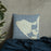 Custom Aquinnah Massachusetts Map Throw Pillow in Woodblock on Bedding Against Wall