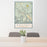 24x36 Arches National Park Map Print Portrait Orientation in Woodblock Style Behind 2 Chairs Table and Potted Plant