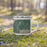 Right View Custom Arnolds Park Iowa Map Enamel Mug in Afternoon on Grass With Trees in Background