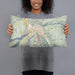 Person holding 20x12 Custom Aspen Colorado Map Throw Pillow in Woodblock