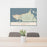 24x36 Astoria Oregon Map Print Landscape Orientation in Woodblock Style Behind 2 Chairs Table and Potted Plant