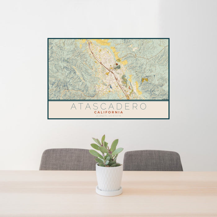 24x36 Atascadero California Map Print Lanscape Orientation in Woodblock Style Behind 2 Chairs Table and Potted Plant
