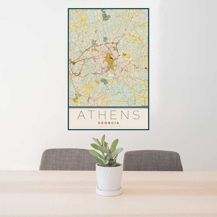 24x36 Athens Georgia Map Print Portrait Orientation in Woodblock Style Behind 2 Chairs Table and Potted Plant