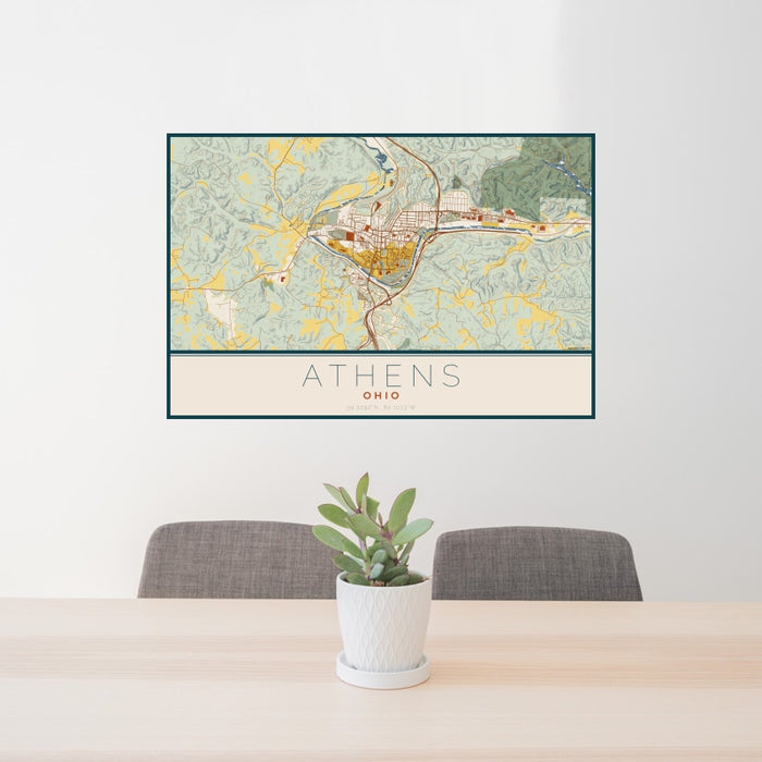 24x36 Athens Ohio Map Print Landscape Orientation in Woodblock Style Behind 2 Chairs Table and Potted Plant
